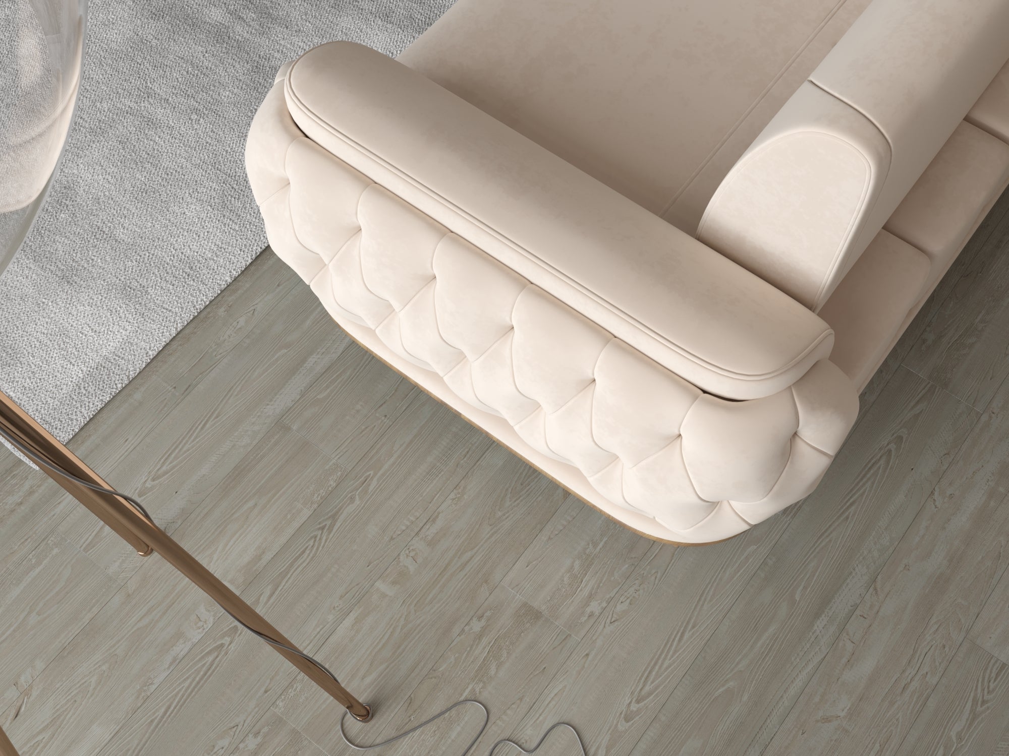 Draufsicht auf die gepolsterte Armlehne eines cremefarbenen Sofas mit quadratischer Steppung auf hellem Holzfußboden.