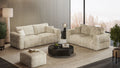 Wohnzimmer mit zwei gestreiften Sofas, Hocker und rundem Couchtisch vor großer Fensterfront mit Stadtblick.