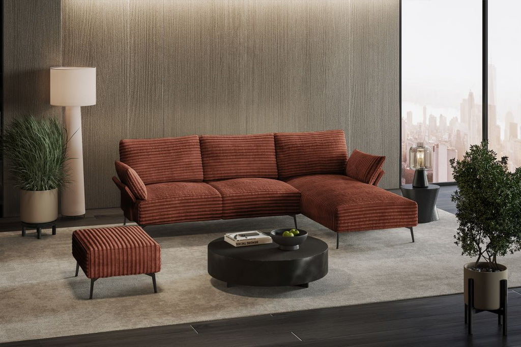 Rostfarbenes Ecksofa mit Rippstoff, Hocker und rundem Couchtisch in modernem Wohnzimmer mit Stadtblick.